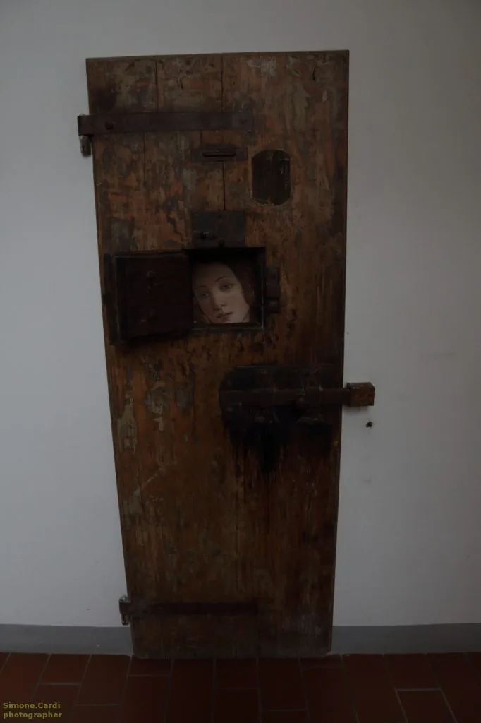 Carcere Le Murate Firenze, antica porta in legno con immagine della Primavera di Botticelli