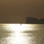 Tramonto Capo Caccia Alghero barca nel sole